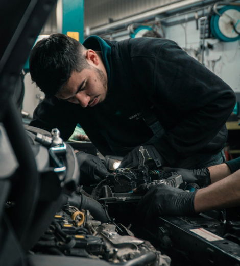 man in black jacket and blue denim jeans riding motorcycle
